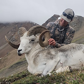 Hunter holding a Stone's sheep